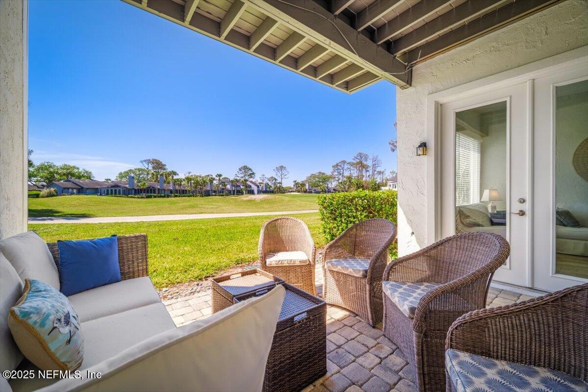 25 Tifton Way South Ponte Vedra Beach, FL 32082 - Photo 39 of 59 a balcony with furniture and a floor to ceiling window