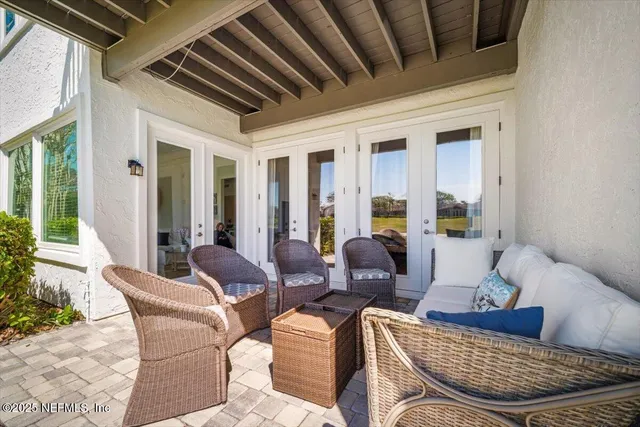 a view of backyard with swimming pool and outdoor seating