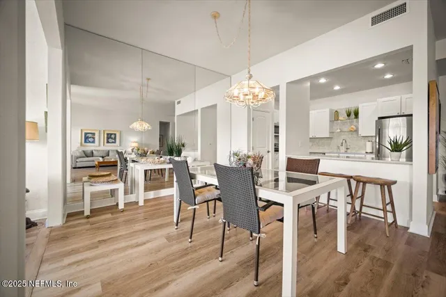 a vase of flowers sitting on a table with a window