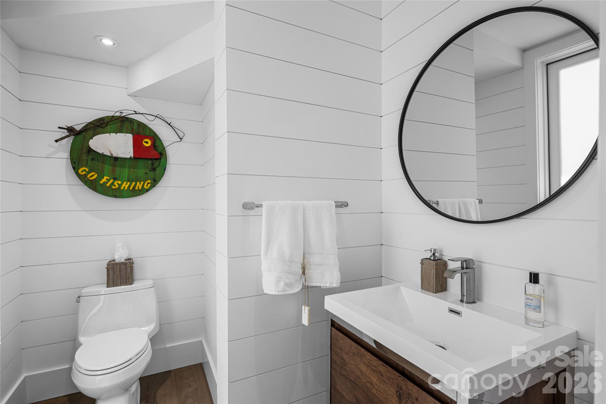 2235 Cold Mountain Road Lake Toxaway, NC 28747 - Photo 24 of 47 a bathroom with a sink a mirror and toilet