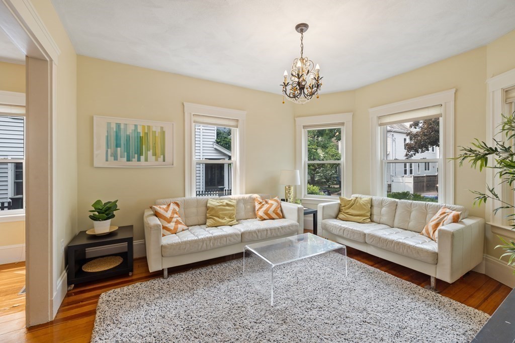 29 Worcester Street, Unit 1 Belmont, MA 02478 - Photo 11 of 27 a living room with furniture and a chandelier