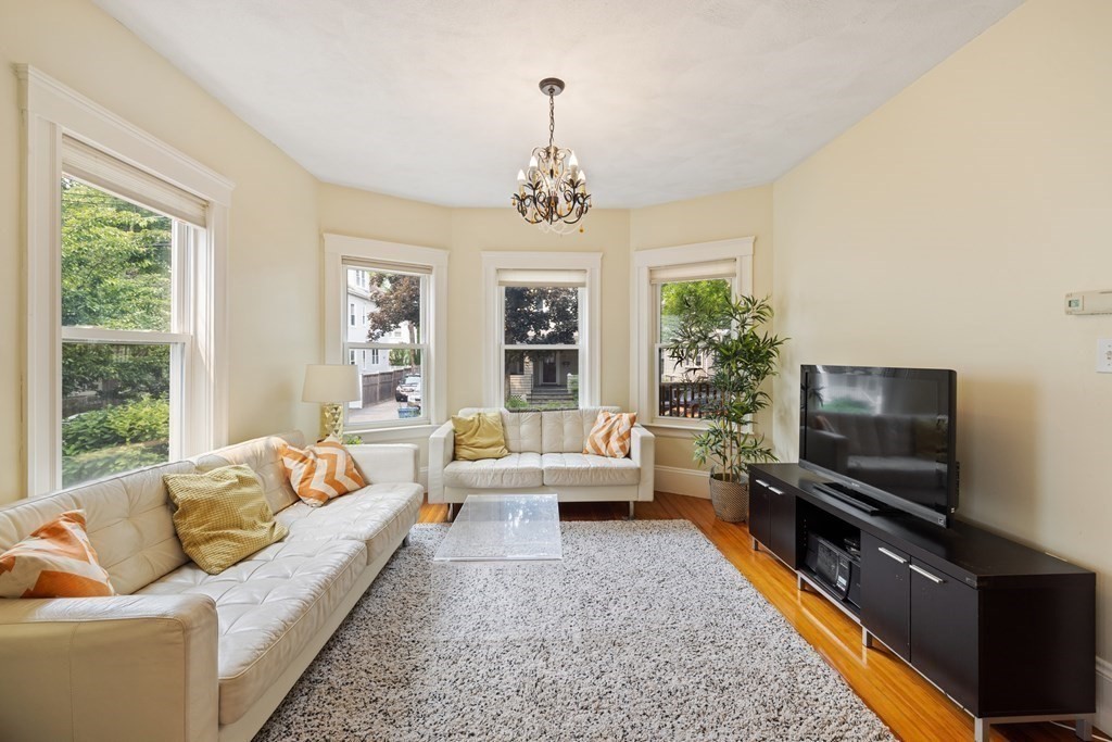 29 Worcester Street, Unit 1 Belmont, MA 02478 - Photo 12 of 27 a living room with furniture flat screen tv and a large window