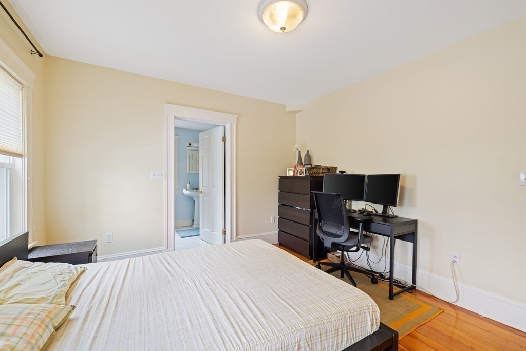 29 Worcester Street, Unit 1 Belmont, MA 02478 - Photo 15 of 27 a bedroom with a bed and a computer on a table