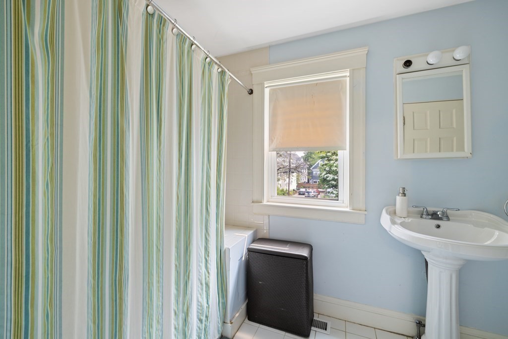 29 Worcester Street, Unit 1 Belmont, MA 02478 - Photo 16 of 27 a bathroom with a sink a mirror and a window