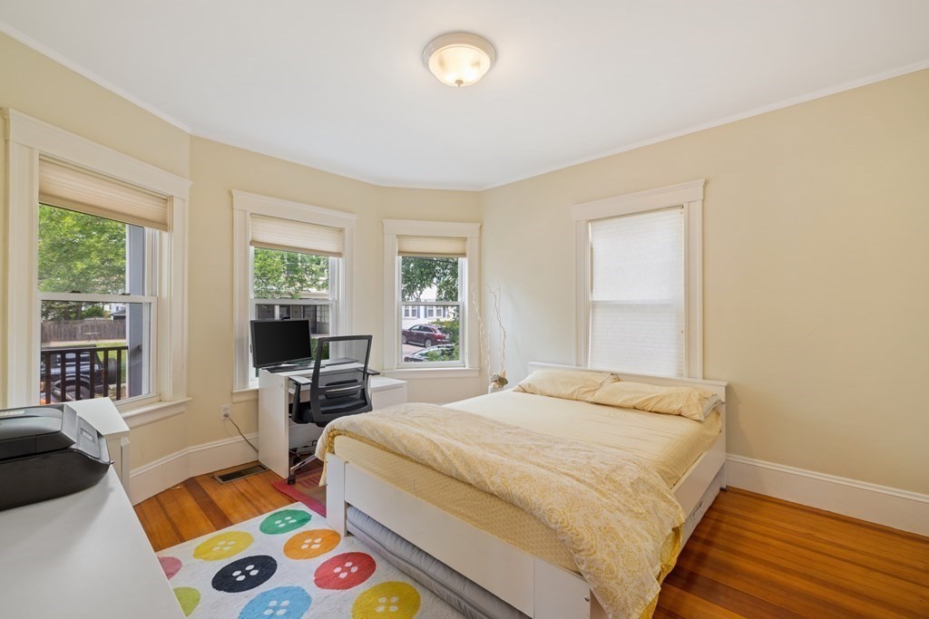 29 Worcester Street, Unit 1 Belmont, MA 02478 - Photo 19 of 27 a bedroom with a bed and wooden floor