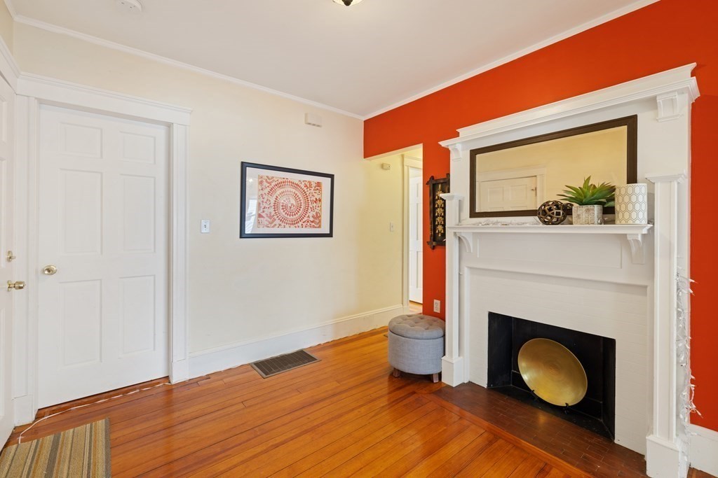 29 Worcester Street, Unit 1 Belmont, MA 02478 - Photo 2 of 27 a view of an empty room with wooden floor and a fireplace