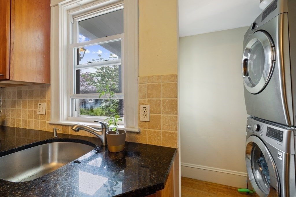 29 Worcester Street, Unit 1 Belmont, MA 02478 - Photo 22 of 27 a bathroom with a granite countertop sink and a bathtub