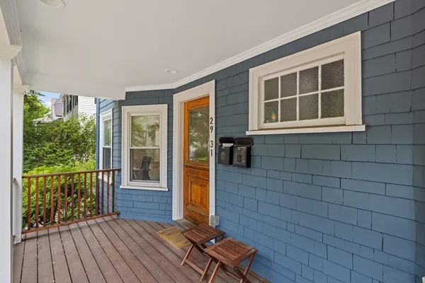 a view of a deck with wooden floor and floor to ceiling window