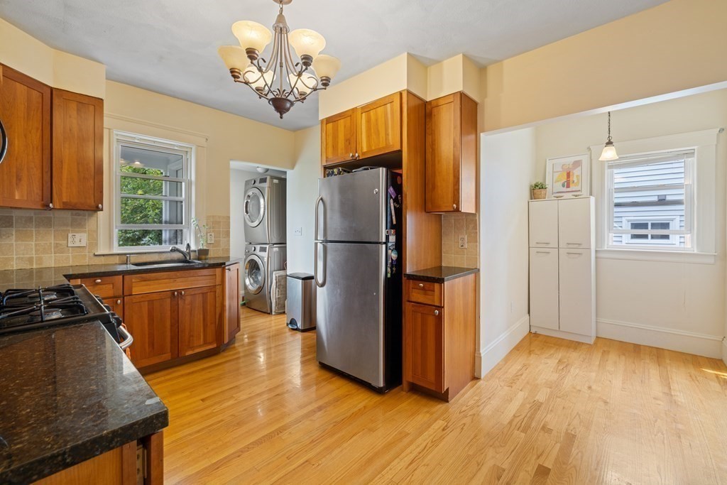 29 Worcester Street, Unit 1 Belmont, MA 02478 - Photo 5 of 27 a kitchen with stainless steel appliances granite countertop a refrigerator a stove and a wooden floors