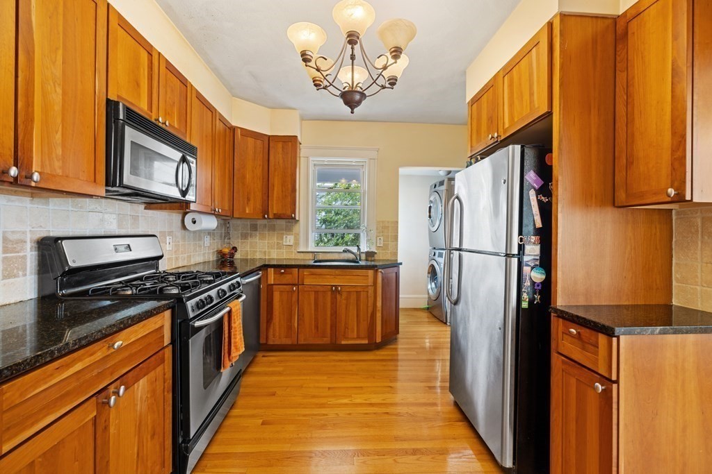 29 Worcester Street, Unit 1 Belmont, MA 02478 - Photo 6 of 27 a kitchen with stainless steel appliances granite countertop a refrigerator a stove top oven a sink and dishwasher