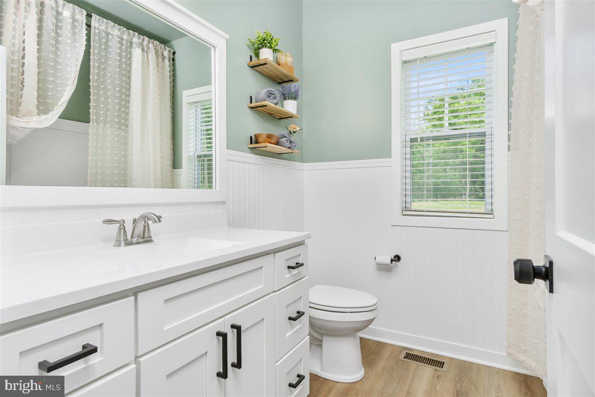 2390 Shirley Road Charles Town, WV 25414 - Photo 41 of 69 a bathroom with a sink a toilet and a window
