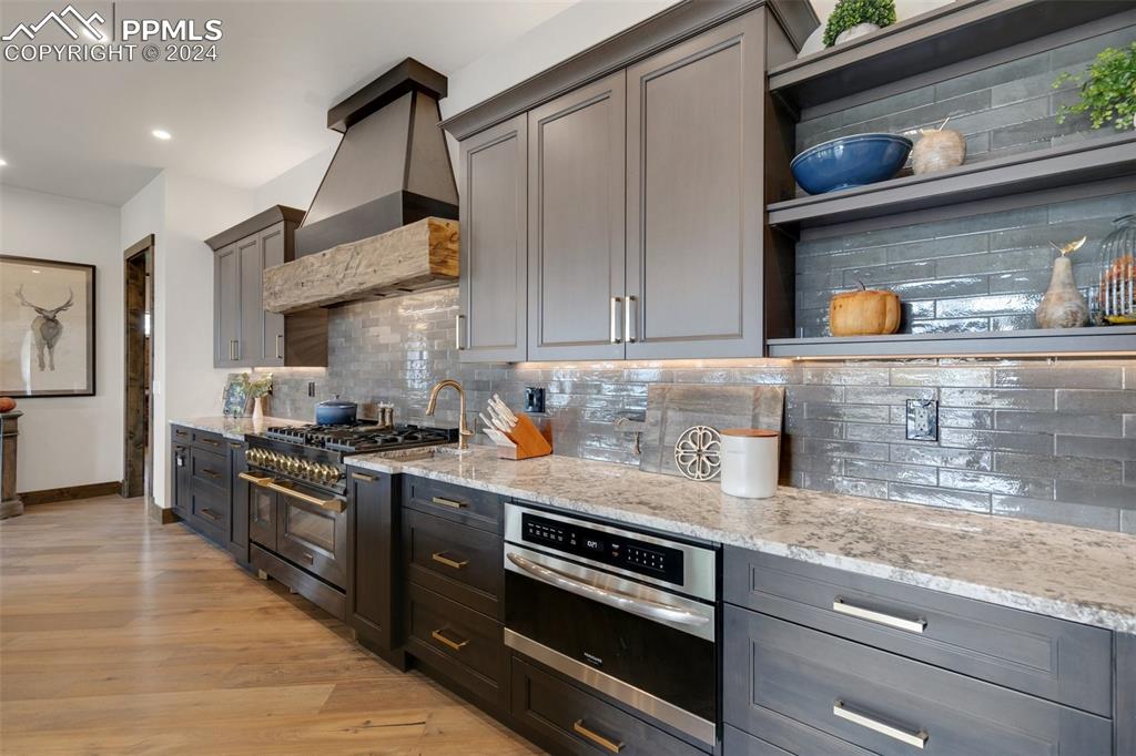 14040 Shadow Pines Road Colorado Springs, CO 80921 - Photo 11 of 50 a kitchen with stainless steel appliances granite countertop a stove and a sink