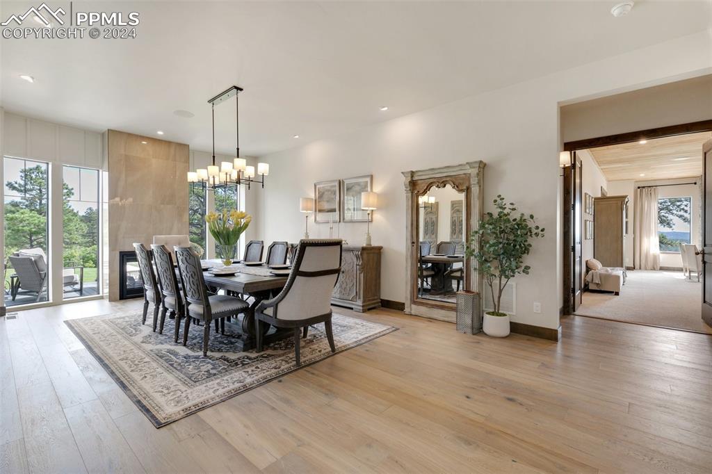 14040 Shadow Pines Road Colorado Springs, CO 80921 - Photo 16 of 50 a view of a dining room with furniture window and wooden floor