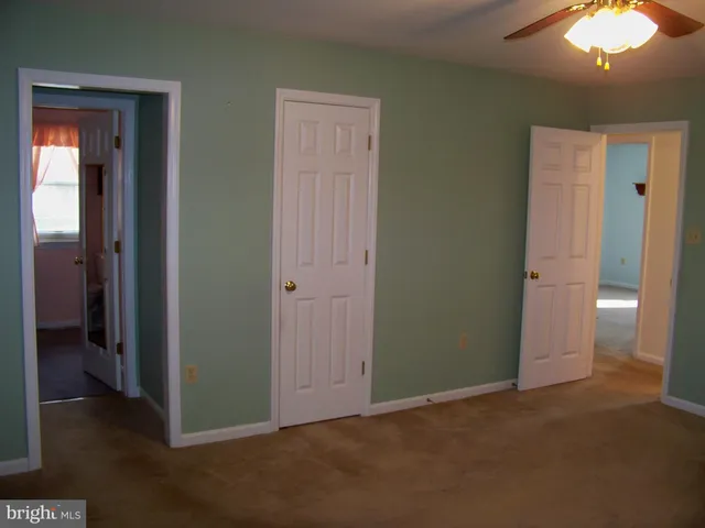 an empty room with closet and a bathroom