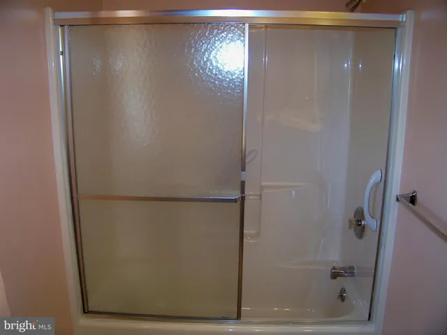 a bathroom with a glass shower door