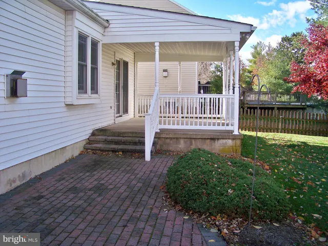 a view of a house with wooden deck and a yard