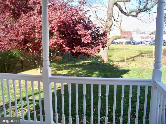 a view of a wooden fence next to a large tree