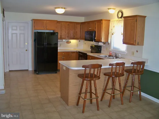 a kitchen with stainless steel appliances a refrigerator and a stove top oven