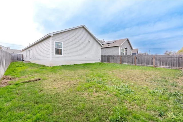 a view of a house with a yard and sitting area