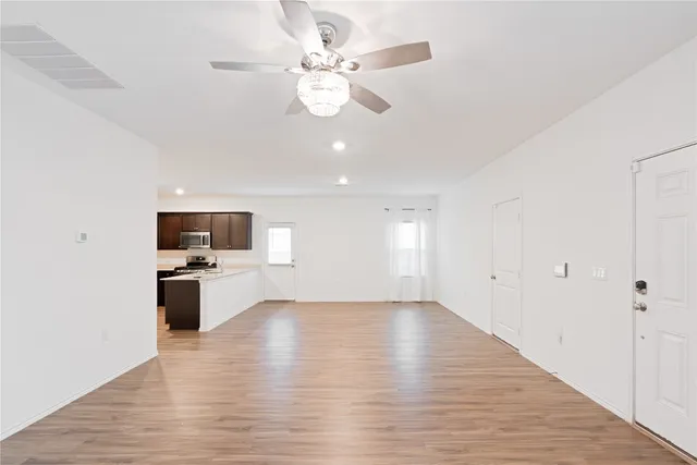 a view of kitchen with sink microwave refrigerator and stove