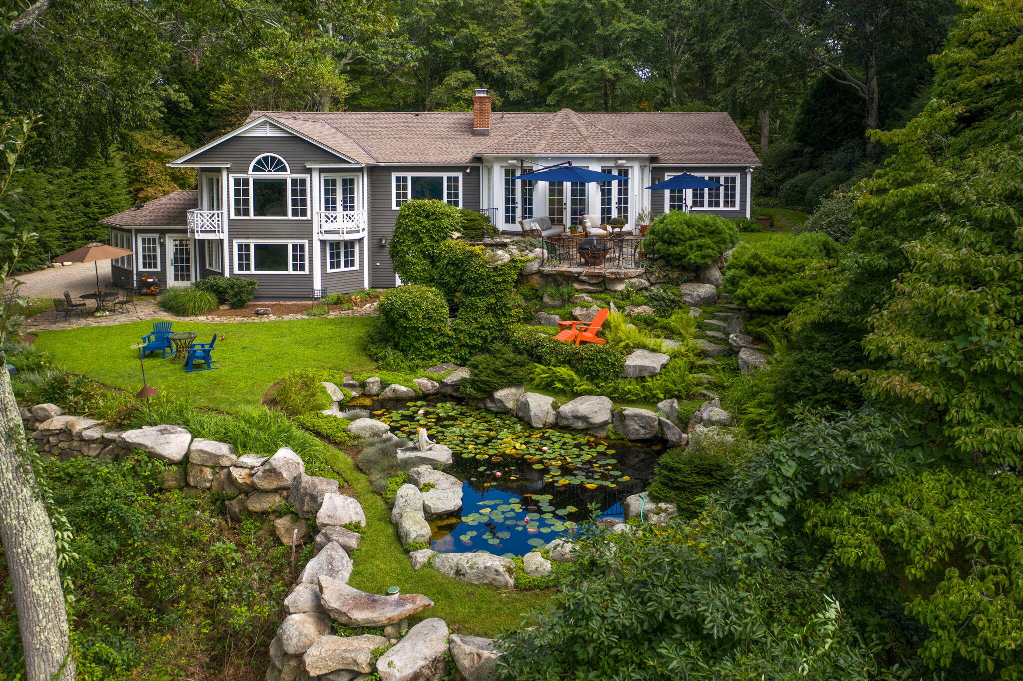 147 Fox Run Road New Canaan, CT 06840 - Photo 1 of 65 a front view of a house with a yard and potted plants