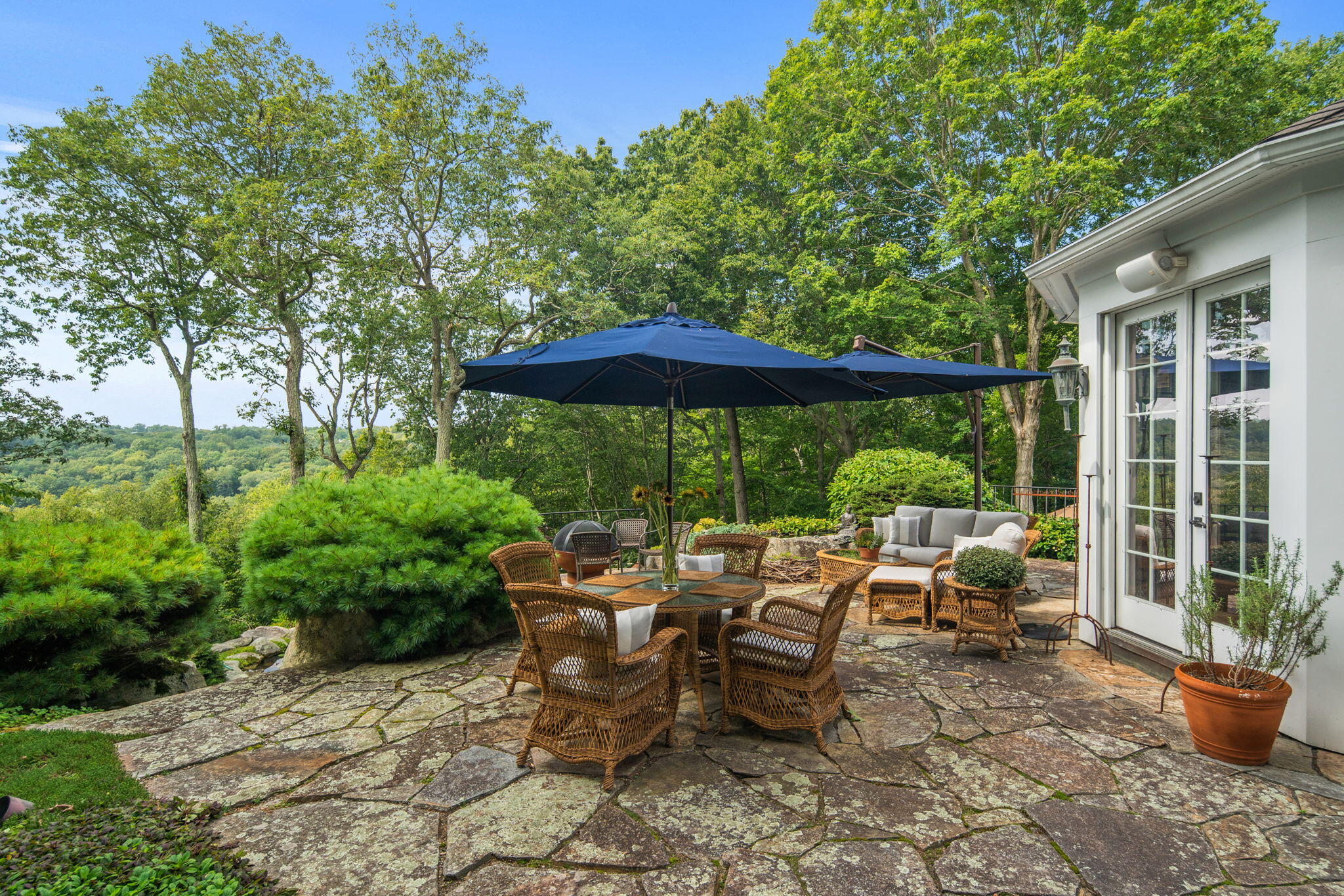 147 Fox Run Road New Canaan, CT 06840 - Photo 20 of 65 a view of a tables and chairs under an umbrella