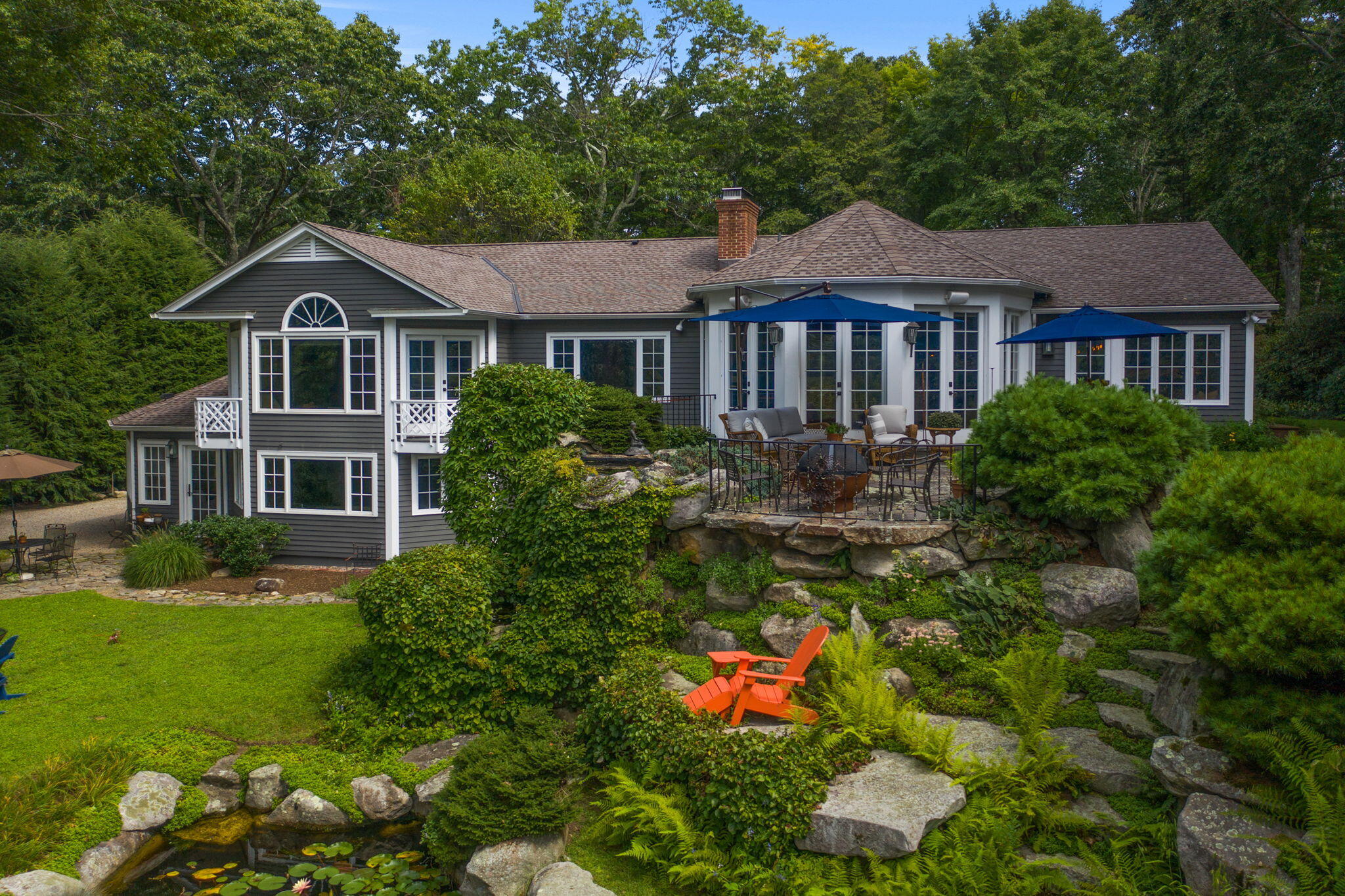 147 Fox Run Road New Canaan, CT 06840 - Photo 50 of 65 a front view of a house with a yard and potted plants