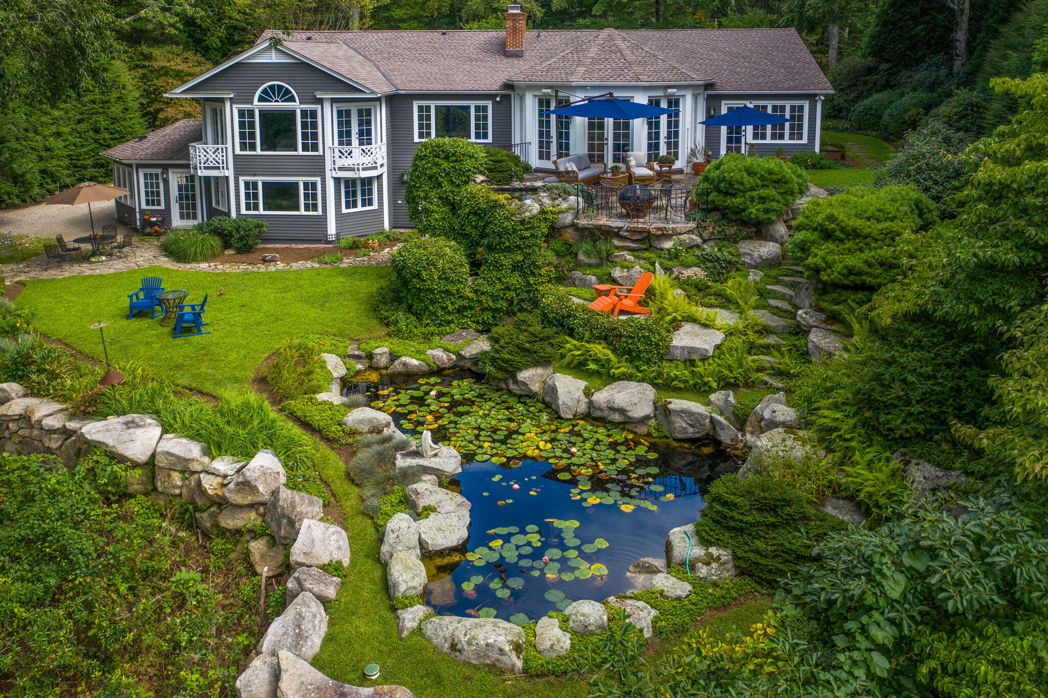 147 Fox Run Road New Canaan, CT 06840 - Photo 53 of 65 a front view of a house with a yard and flower plants