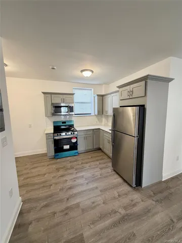 a kitchen with a refrigerator and a stove