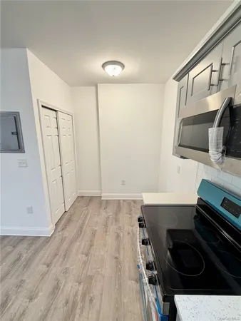 a kitchen with a stove microwave and sink