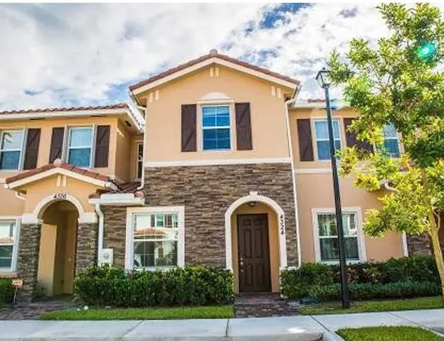 a view of house with backyard
