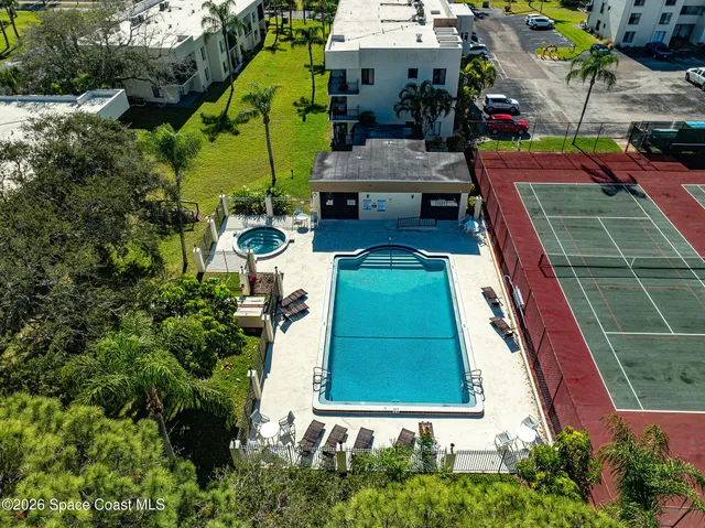 an aerial view of a house with a swimming pool