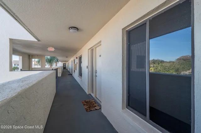 a living room with furniture gym equipment and a book shelf