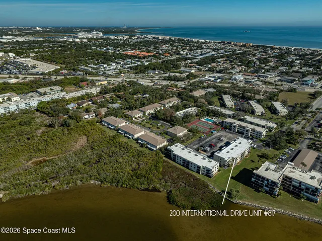 an aerial view of residential building with ocean