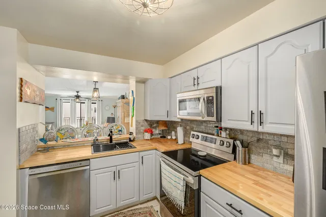 a kitchen with stainless steel appliances a sink stove and cabinets