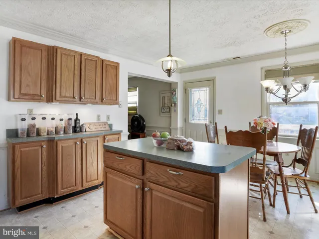a kitchen with a sink cabinets and window