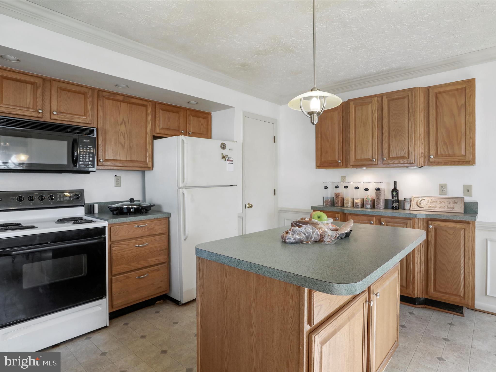 239 Chestnut Street Winchester, VA 22601 - Photo 14 of 35 a kitchen with stainless steel appliances granite countertop a sink stove and refrigerator
