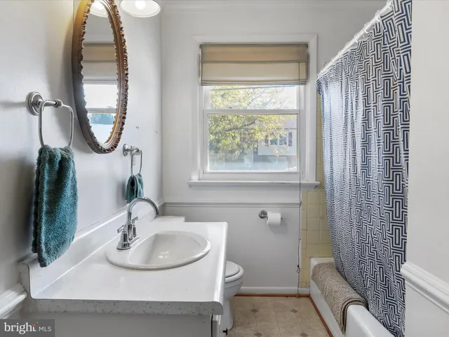 a bathroom with a sink toilet and a mirror