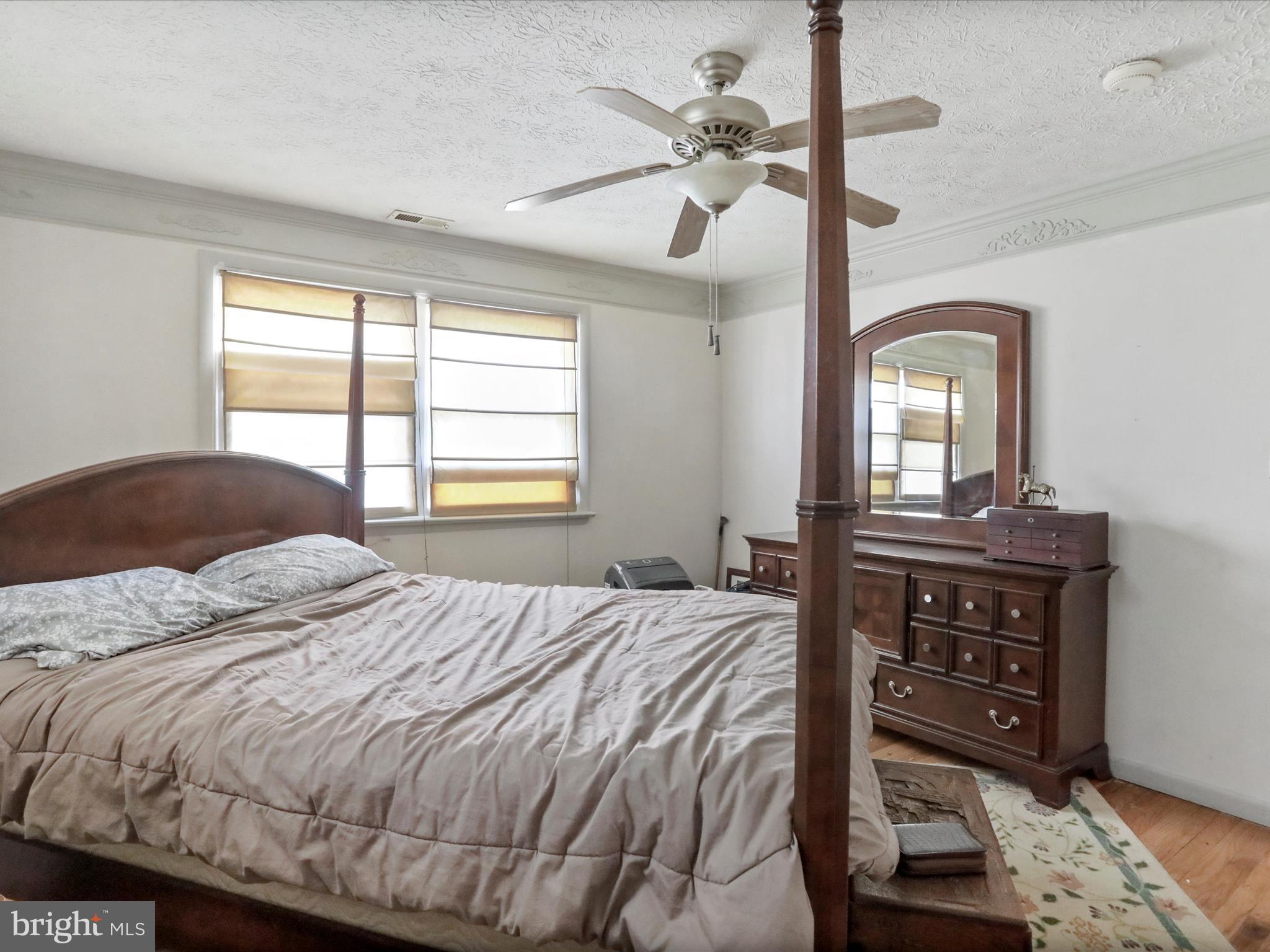 239 Chestnut Street Winchester, VA 22601 - Photo 20 of 35 a bedroom with a bed a dresser with wooden floor