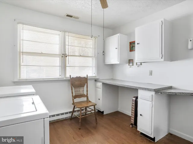 a room with a window and chairs