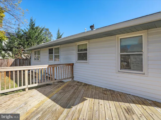 a view of a wooden deck with a yard