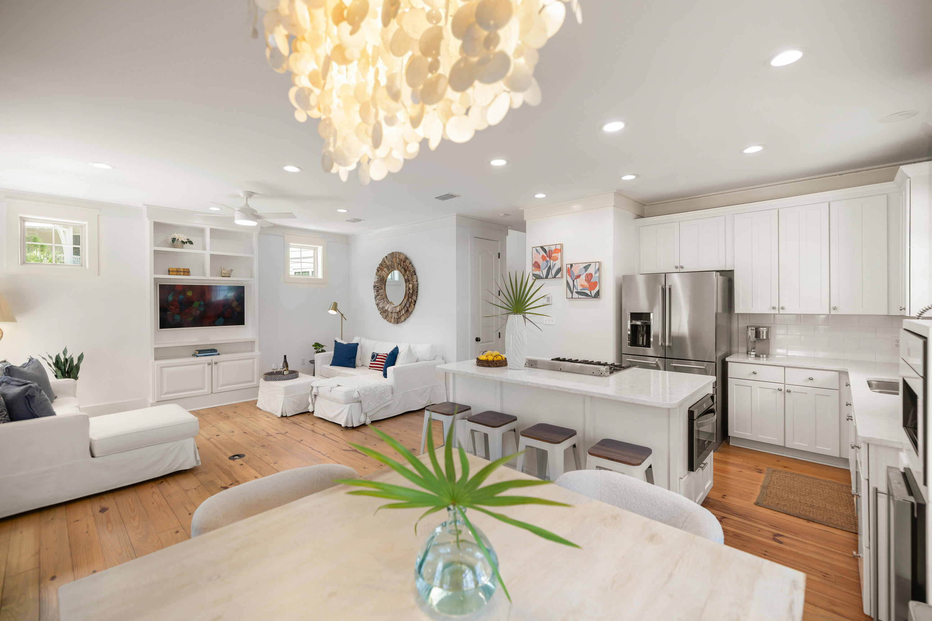a living room with kitchen island furniture and a chandelier