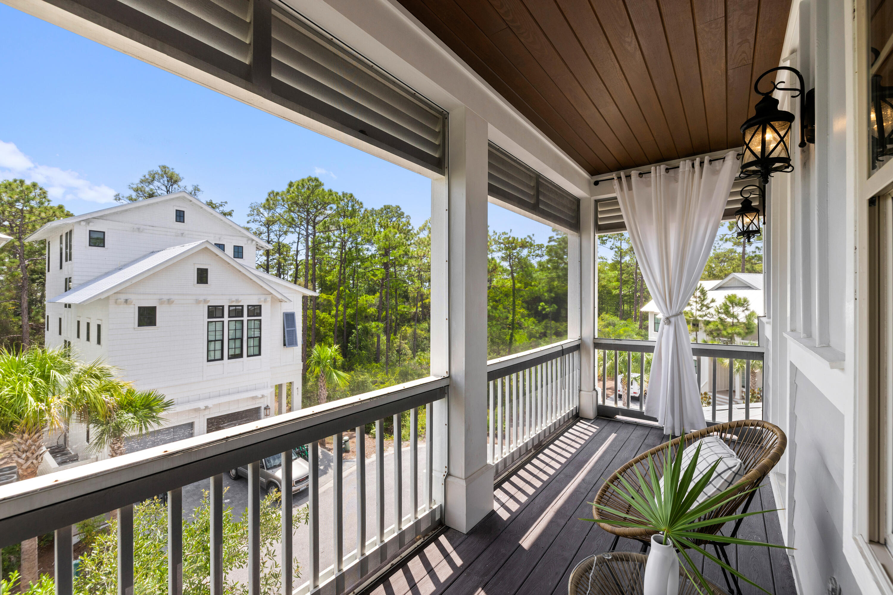 402 Redbud Lane Inlet Beach, FL 32461 - Photo 28 of 44 a view of a patio with table and chairs potted plants with wooden floor