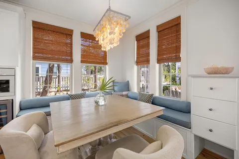 a living room with furniture and large windows