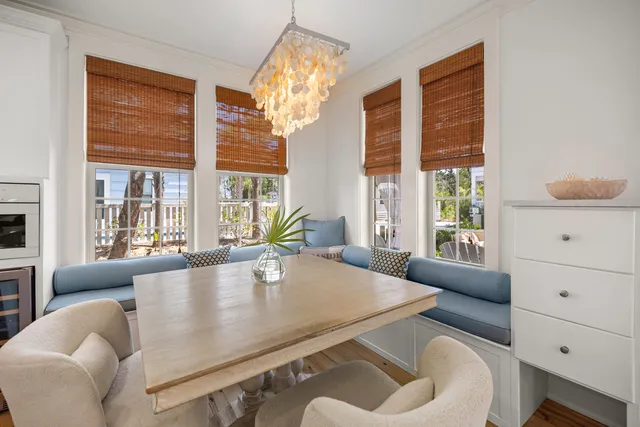 a living room with furniture and large windows
