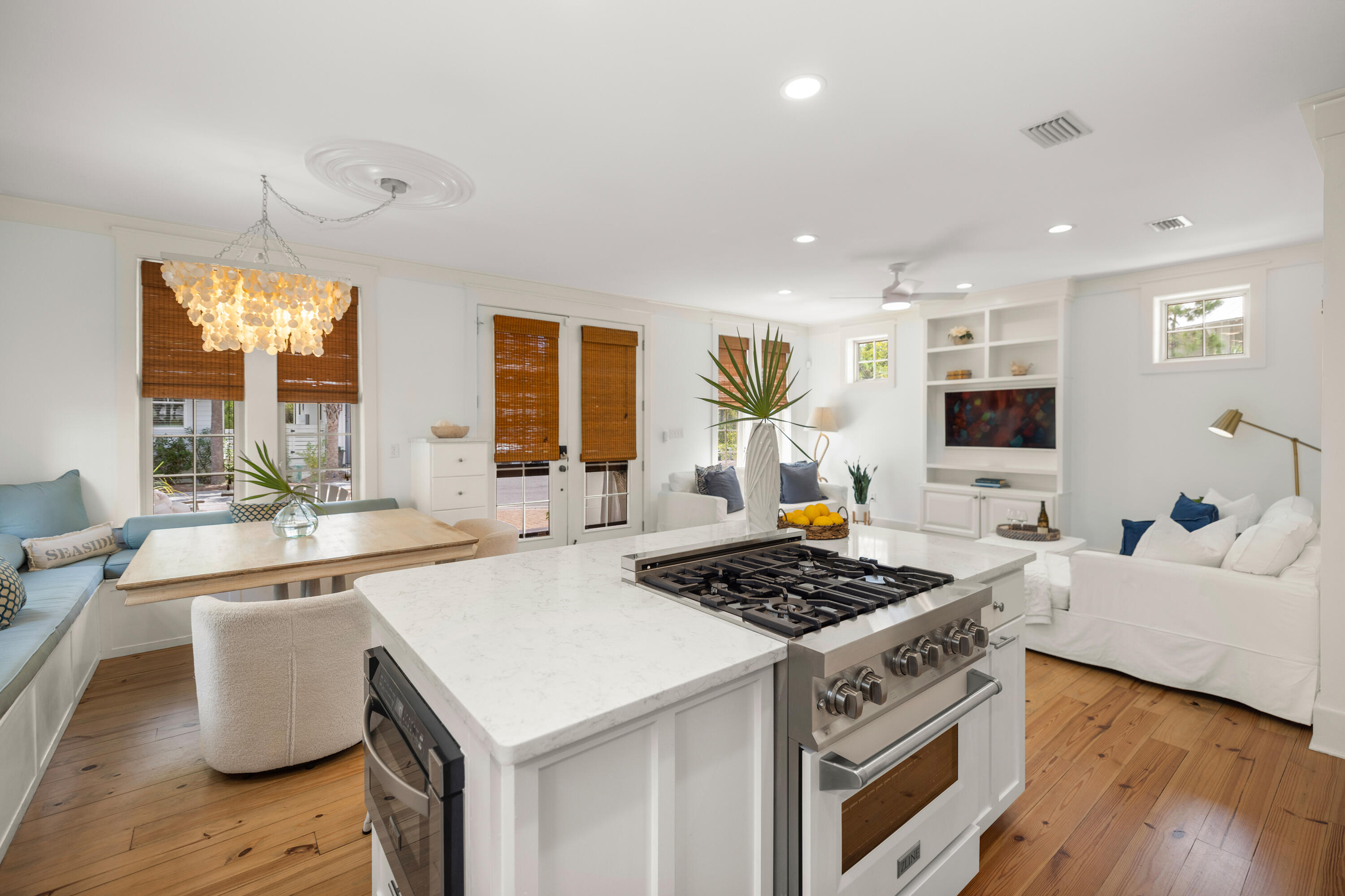 402 Redbud Lane Inlet Beach, FL 32461 - Photo 5 of 44 a kitchen with a stove a sink a kitchen island with wooden cabinets and wooden floor