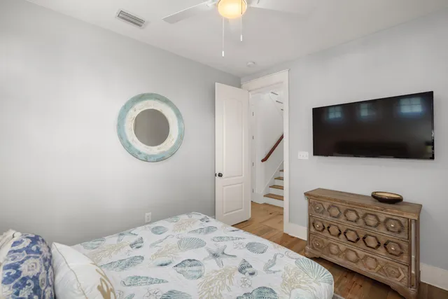 a bedroom with a bed and a flat screen tv