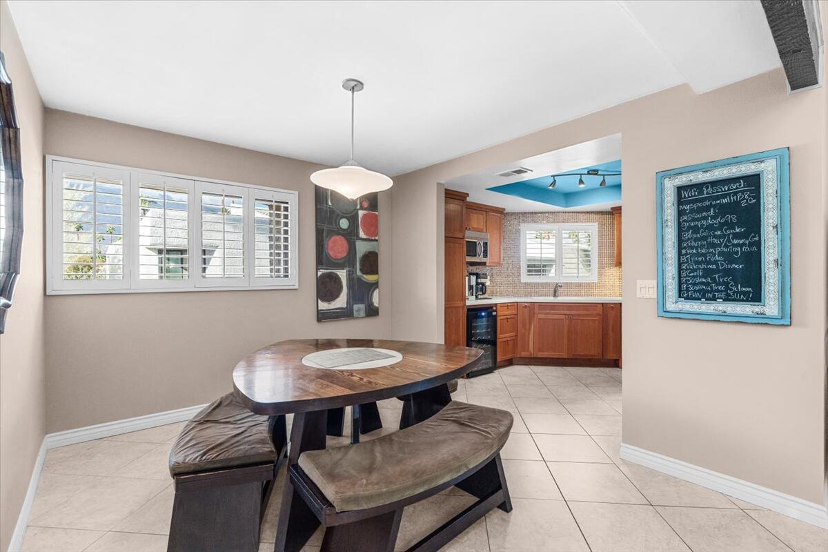 3155 Ramon Road, Unit 312 Palm Springs, CA 92264 - Photo 11 of 34 a view of a dining room with furniture window and wooden floor