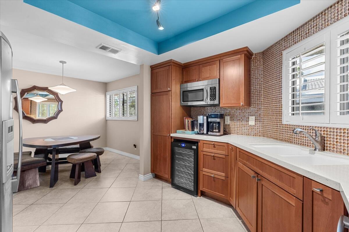3155 Ramon Road, Unit 312 Palm Springs, CA 92264 - Photo 13 of 34 a kitchen with stainless steel appliances a sink a stove a refrigerator cabinets and dining table