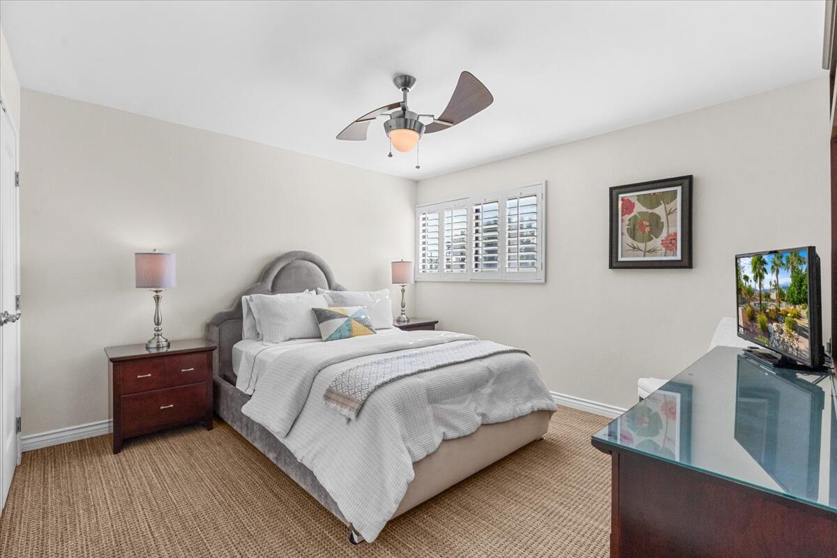 3155 Ramon Road, Unit 312 Palm Springs, CA 92264 - Photo 16 of 34 a bedroom with a bed and a flat screen tv